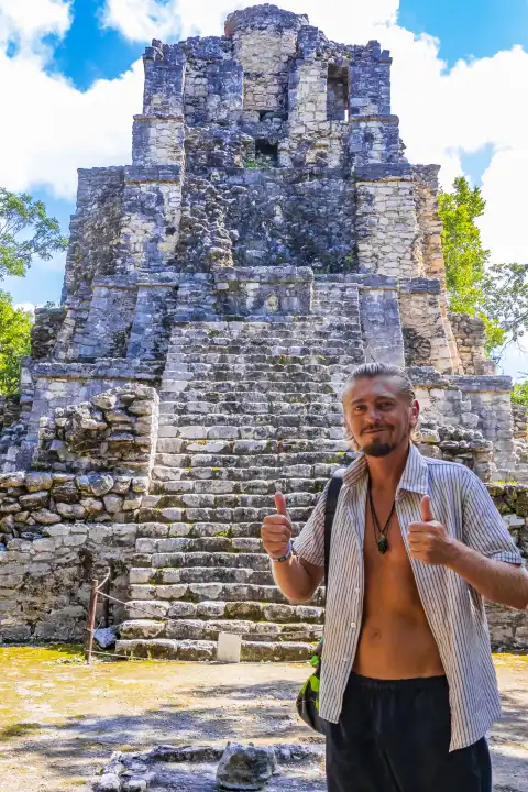 Reisende und Fremdenführerin in der alten Maya-Stätte mit Tempelruinen, Pyramiden und Artefakten im tropischen, natürlichen Dschungelwald mit Palmen und Wanderwegen in Muyil Chunyaxche Quintana Roo Mexiko.