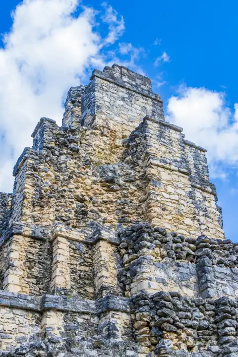 Ancient Mayan site with temple ruins pyramids and artifacts in the tropical natural jungle forest palm trees and walking trails in Muyil Chunyaxche Quintana Roo Mexico.