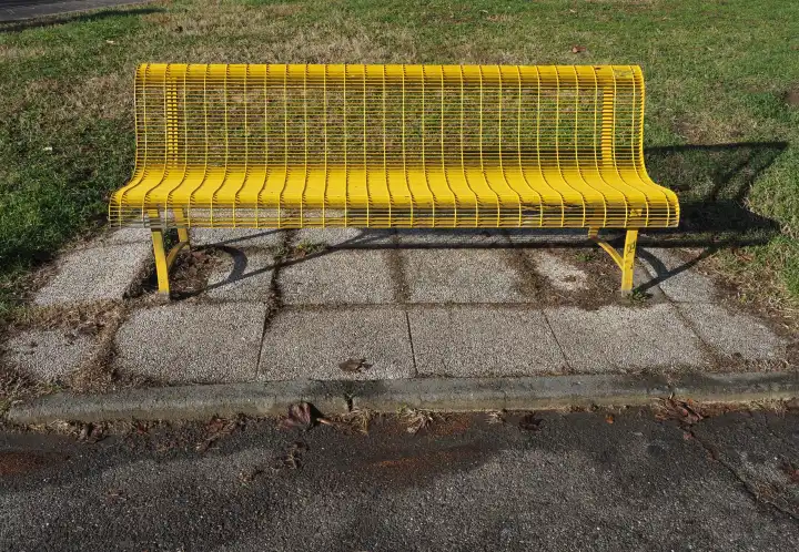 yellow bench chair in a public park