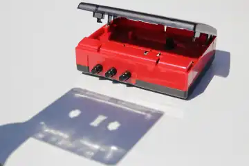 Shadow of cassette tape being inserted into a player