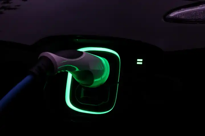 Green light from electric car charger at night