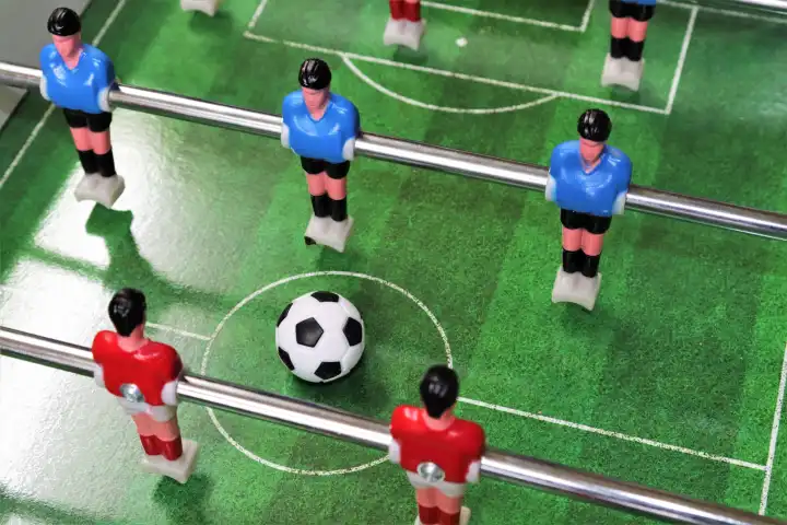 Start of a table top football with red and blue teams