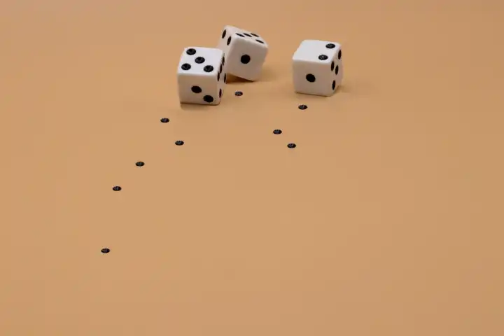Three dice losing their spots as they roll away