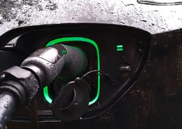 Electric car charging in the rain