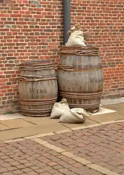 Old barrels of wheat and wine by an old brick wall
