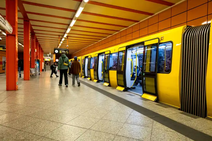Passengers board a Berliner Verkehrsbetriebe (BVG) subway train at Schillingstraße subway station in Berlin.