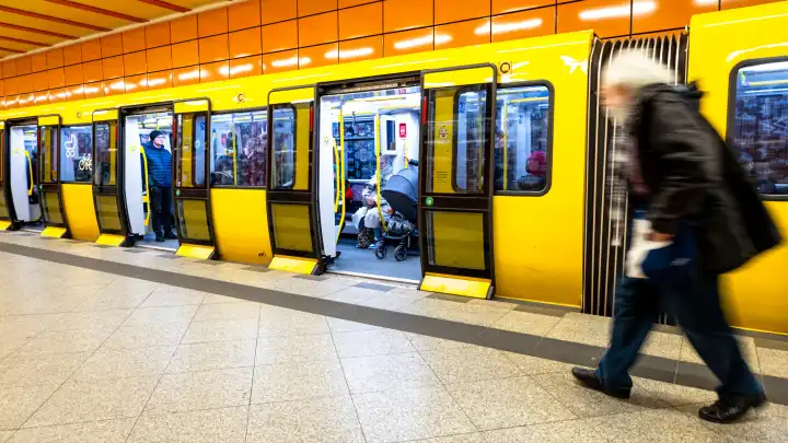 Passengers board a Berliner Verkehrsbetriebe (BVG) subway train at Schillingstraße subway station in Berlin.
