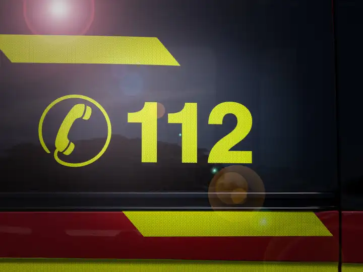 Emergency Hotline 112: Reflective Safety Sign on Rescue Vehicle